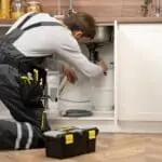 service-maintenance-worker-repairing Drain Clogs