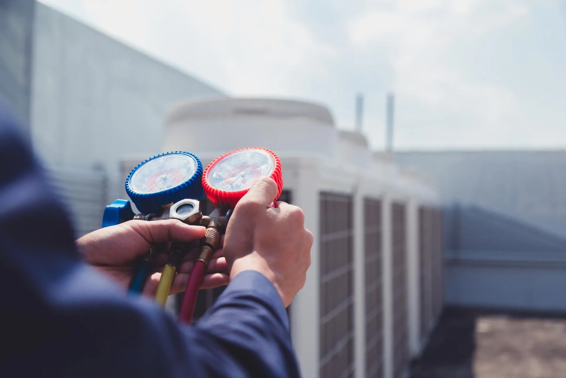 hvac technician inspecting commercial air conditioning system