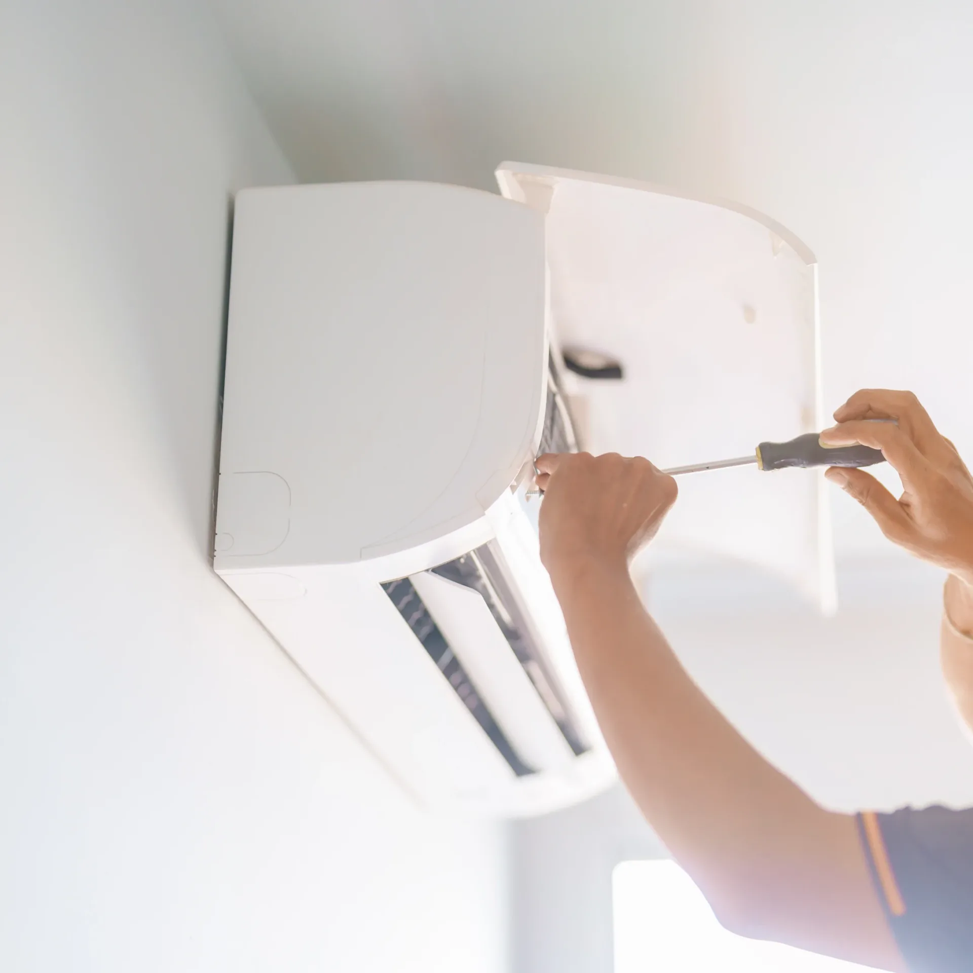 Air conditioning repair service working on an at home unit